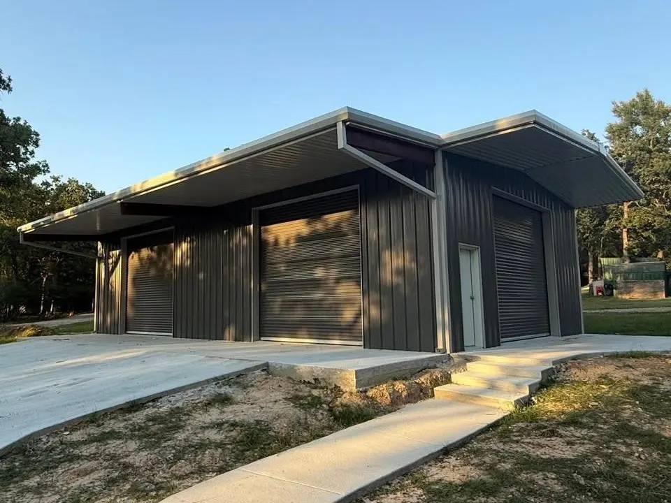 Dark metal shop with a long front overhang