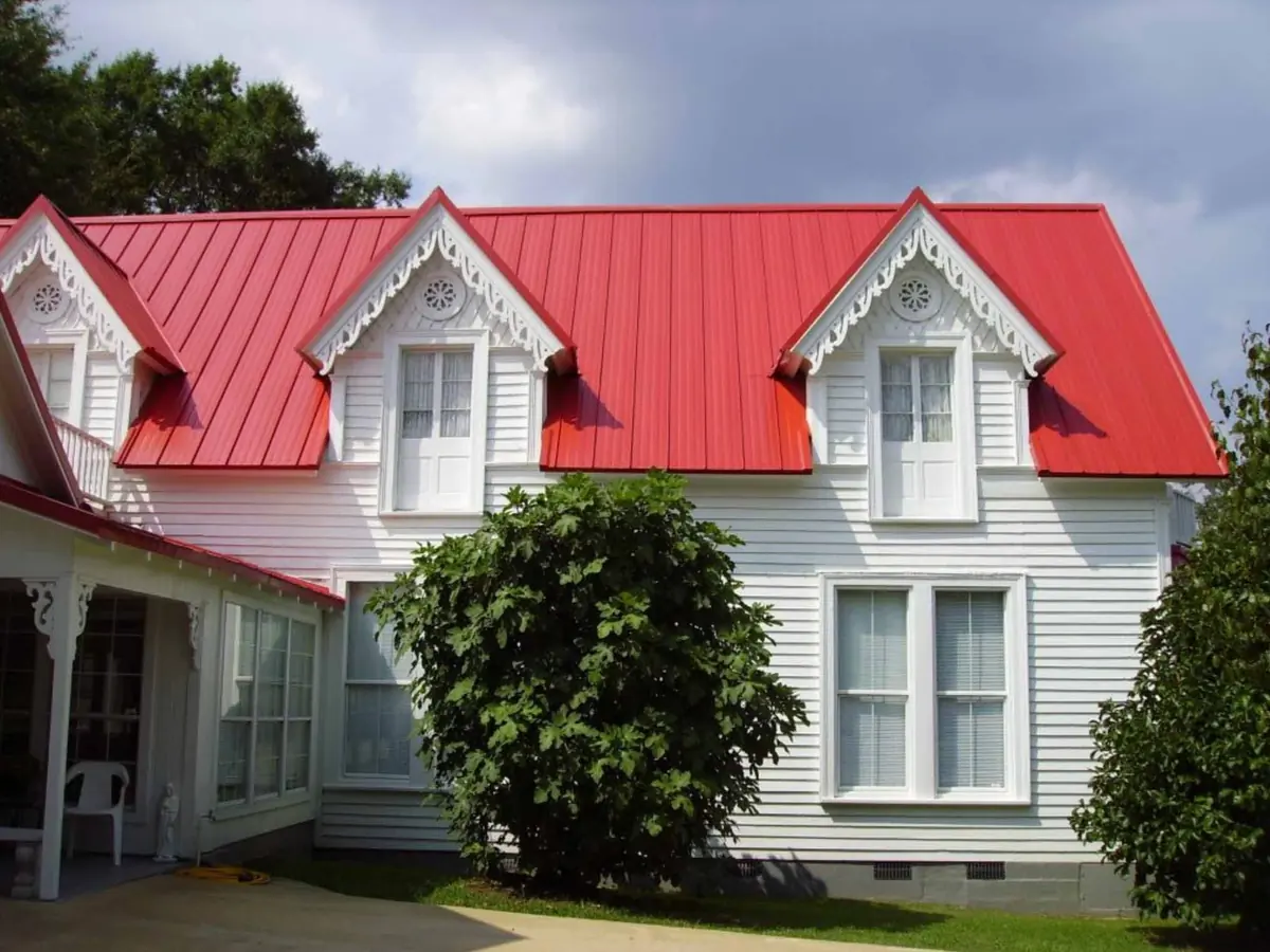 Home with a red metal roof