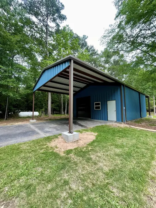 Blue building with a tall attached carport