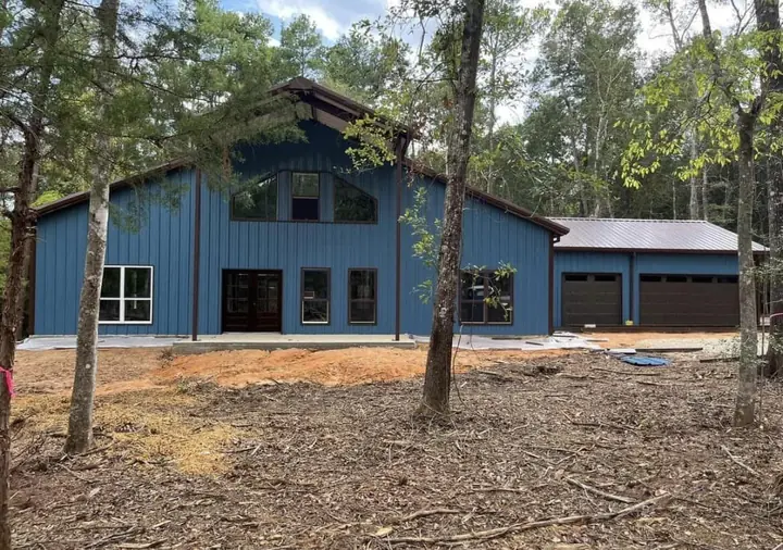 Blue metal home with attached garage
