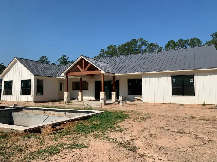 Board-and-batten home with a charcoal metal roof