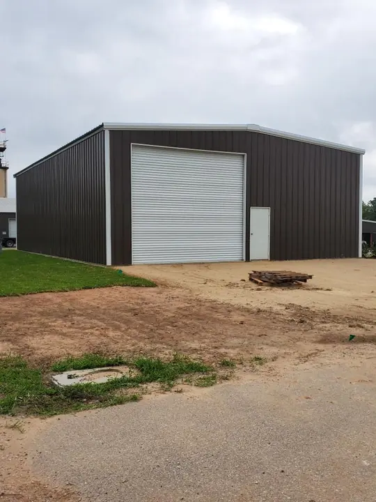 Brown shop with a white roll-up door