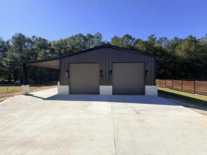 Charcoal metal shop with two roll-up doors