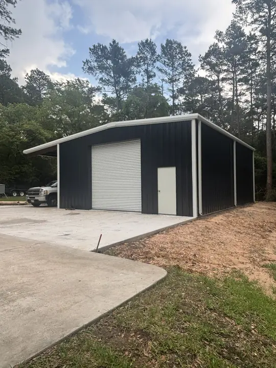 Dark shop with a side carport