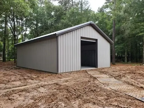 Gray shop in a wooded lot