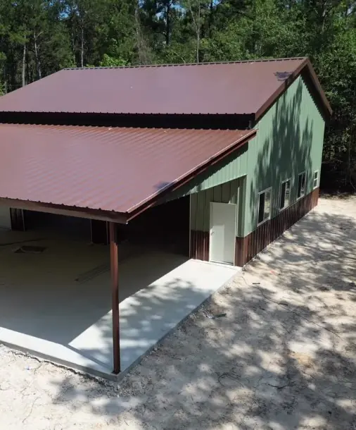 Green building with a brown roof and lean-to