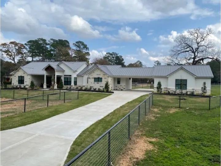 Ranch-style home with a light gray metal roof