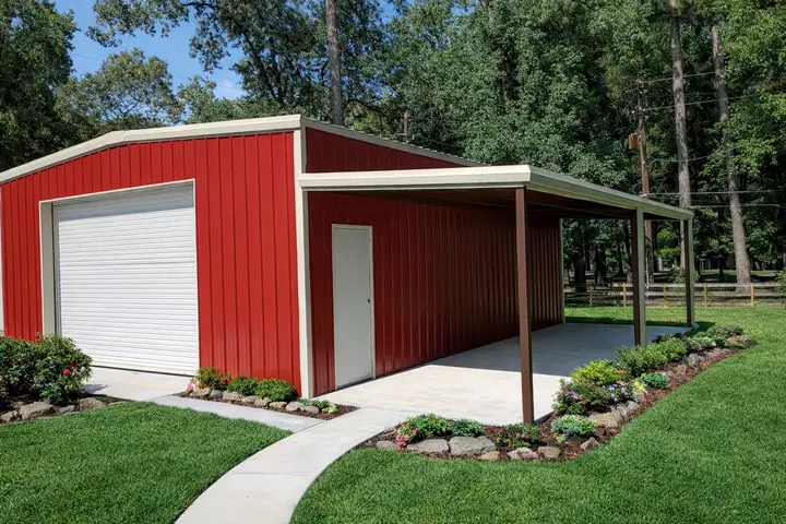 Red metal building with a lean-to and white doors