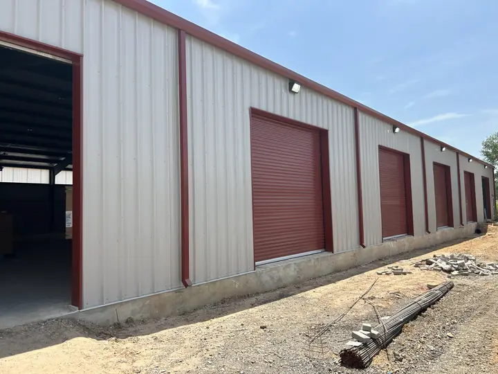 Storage building with red roll-up doors