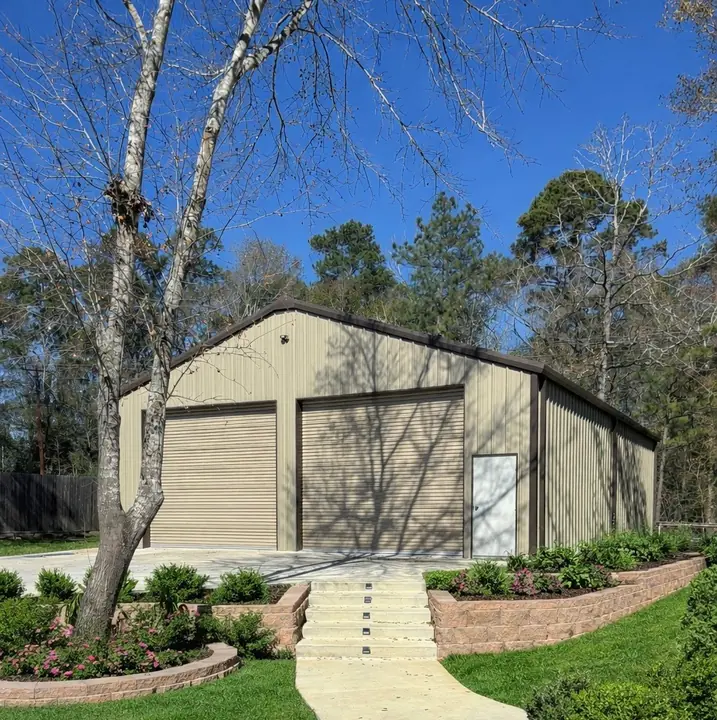 Tan two-door shop with finished landscaping