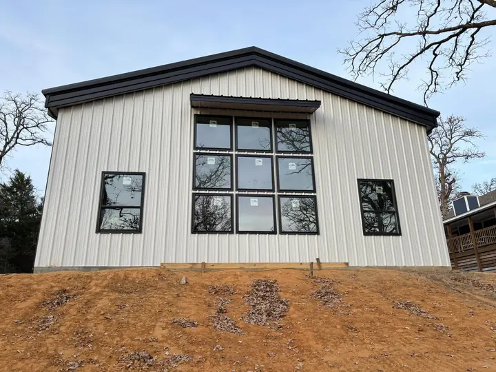 White metal building with a large window wall