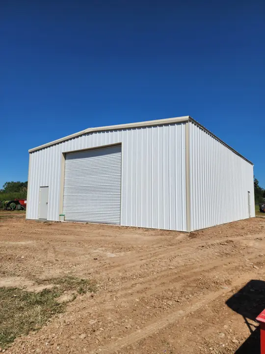 White shop with a tall roll-up door